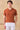Herren-Poloshirt aus rostorangefarbenem Rippstrick